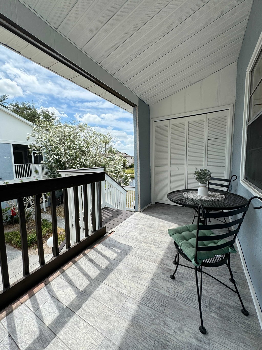 a patio with a table and chairs on a balcony