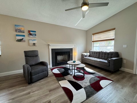 a living room with a rug and a fireplace