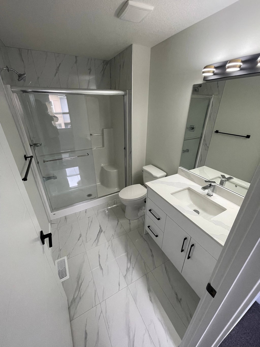 a bathroom with a sink toilet and a mirror