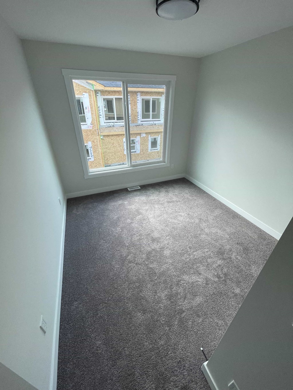 a room with a carpeted floor and a window