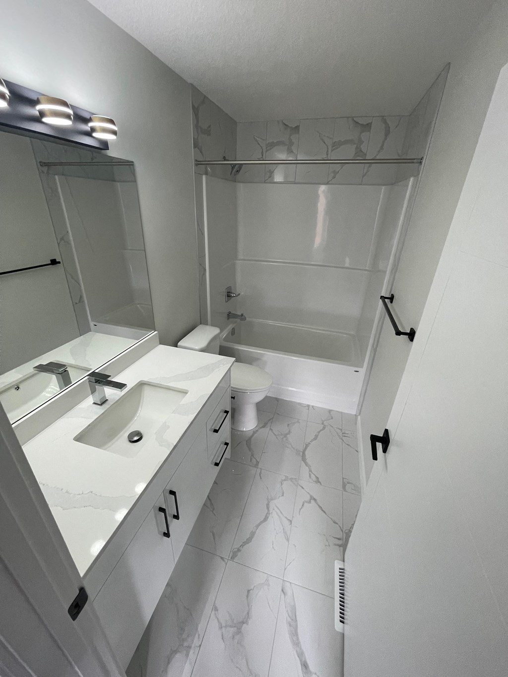 a bathroom with a sink and a toilet and a shower