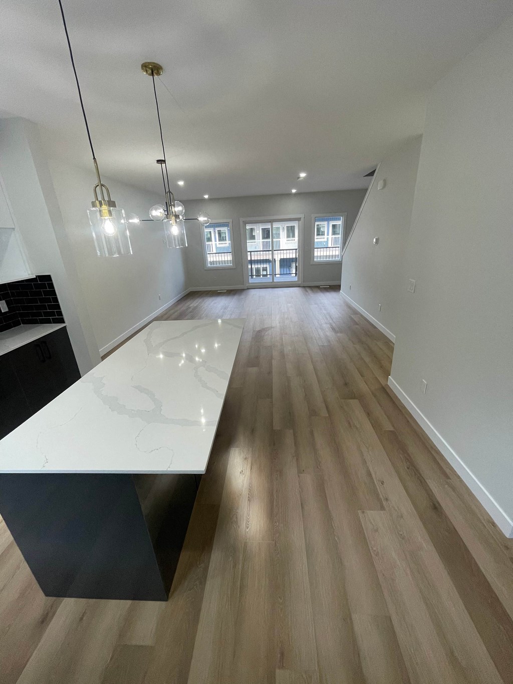 a view from the kitchen into the living room and dining room