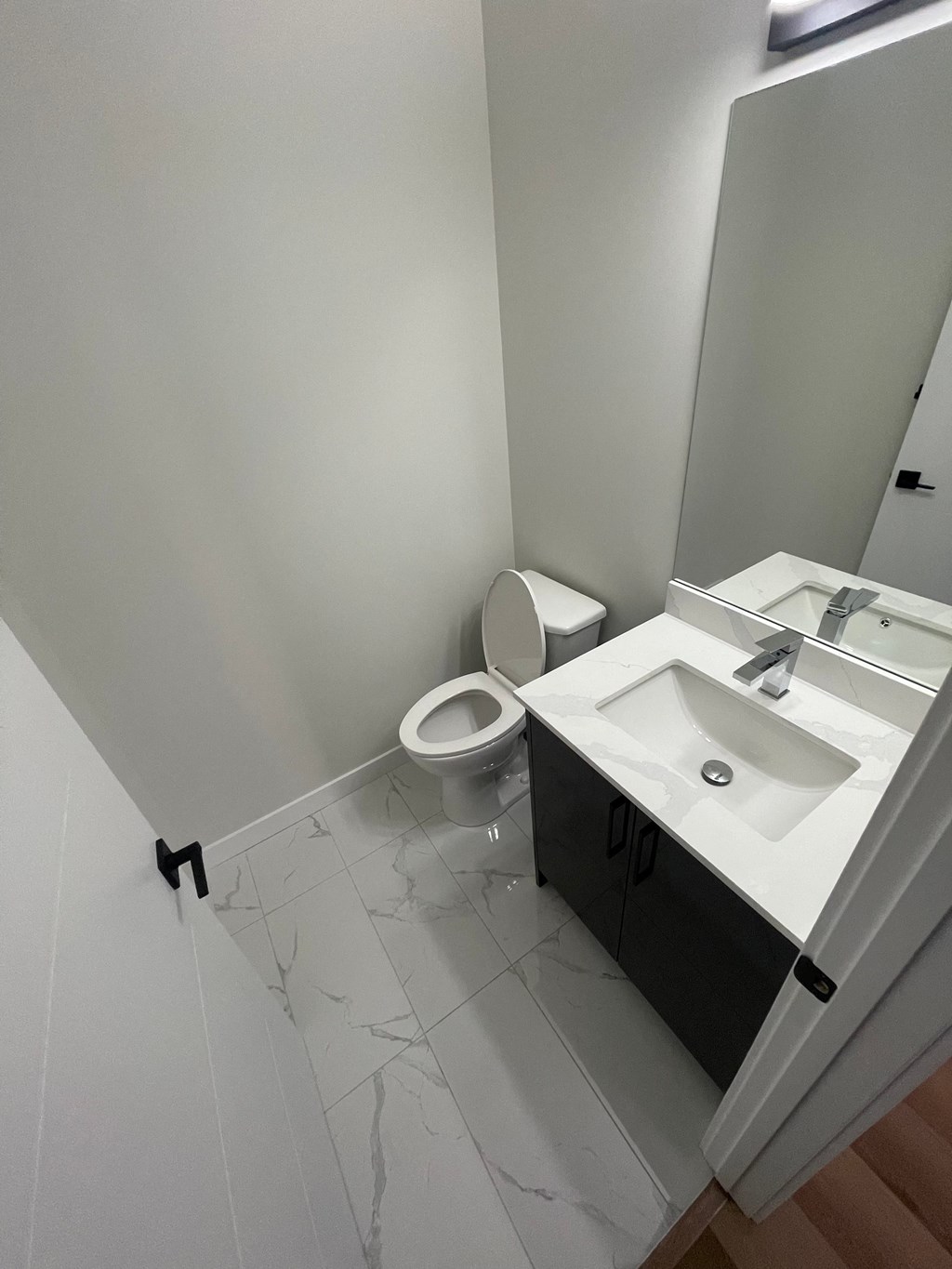 a bathroom with a toilet and a sink and a mirror