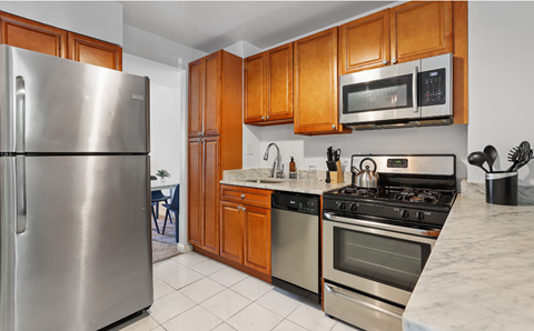 a kitchen with stainless steel appliances and wooden cabinets