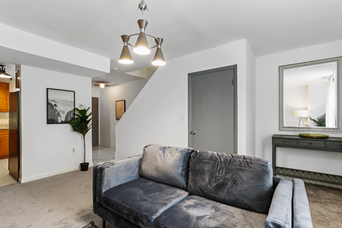 a living room with a couch and a door to a bathroom