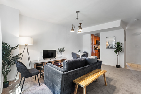 a living room with a couch and a desk with a tv