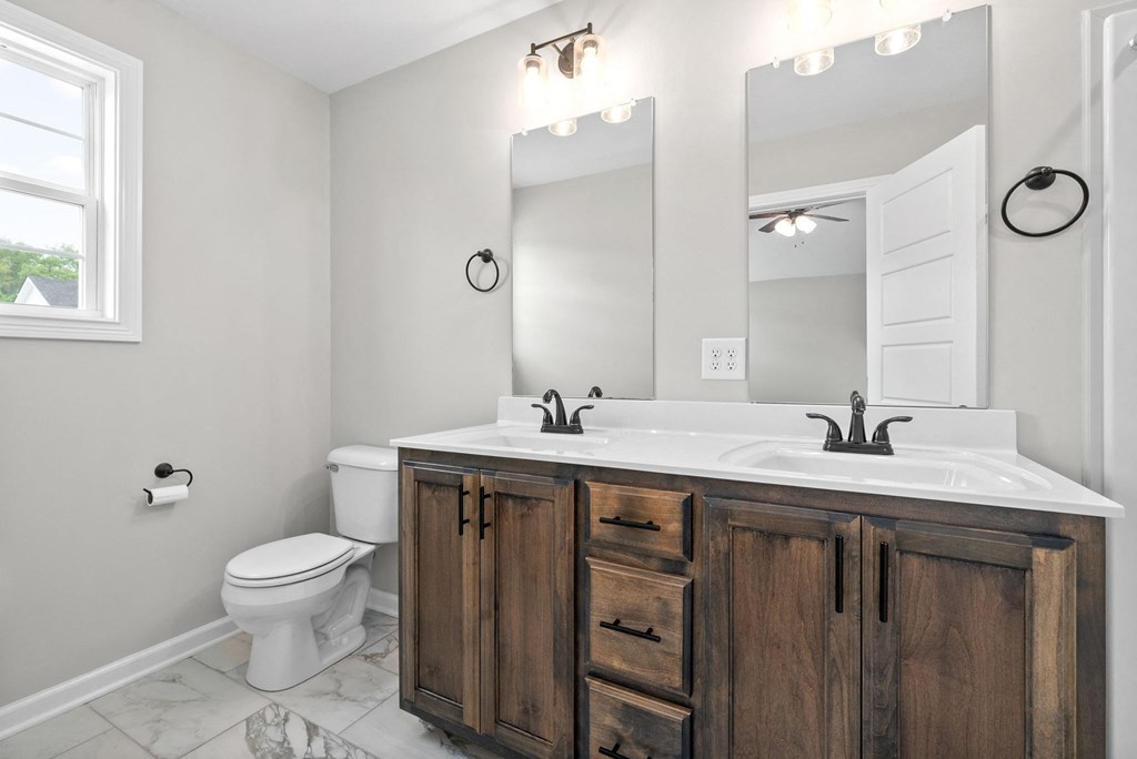 a bathroom with a sink and a toilet and a mirror