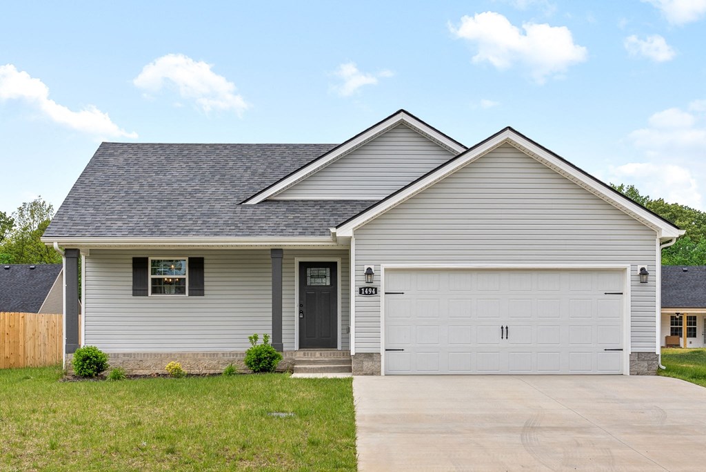 a white house with a driveway and a garage door