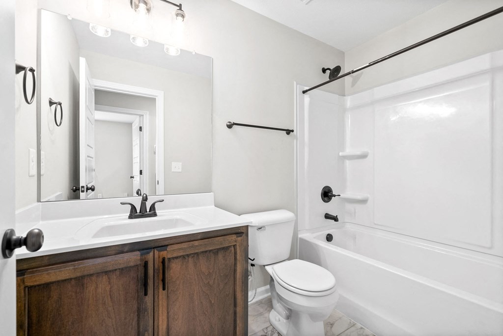 a bathroom with a sink toilet and a shower
