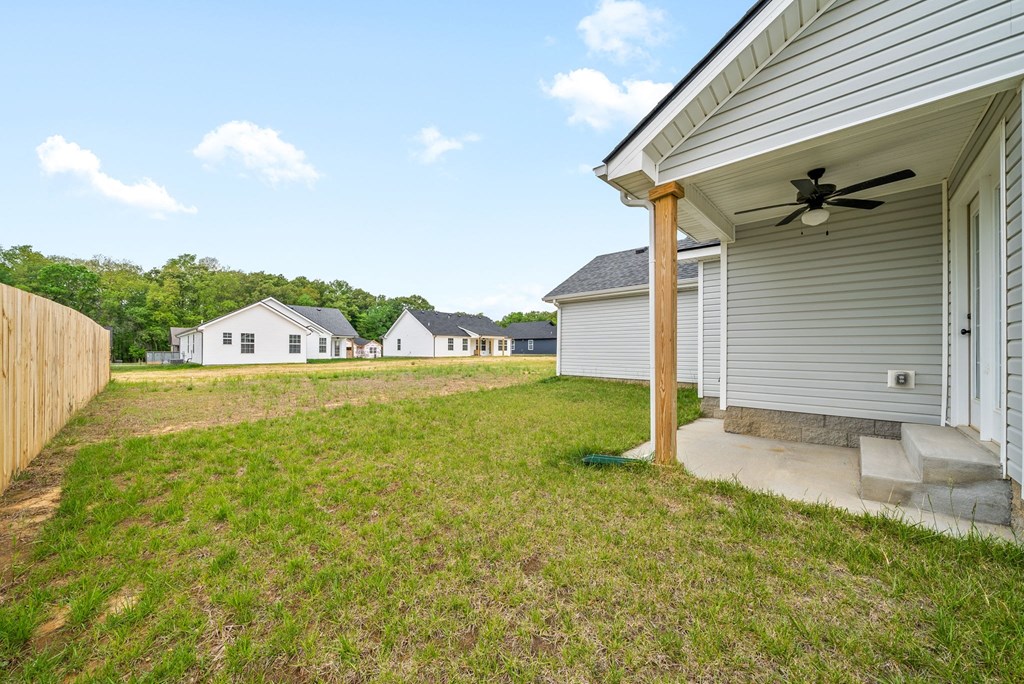 the backyard of a house with a yard and a porch