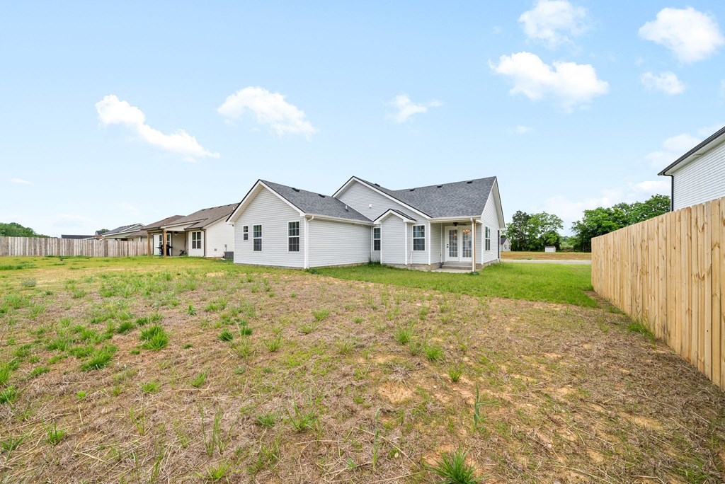 a row of white houses in a fenced in yard