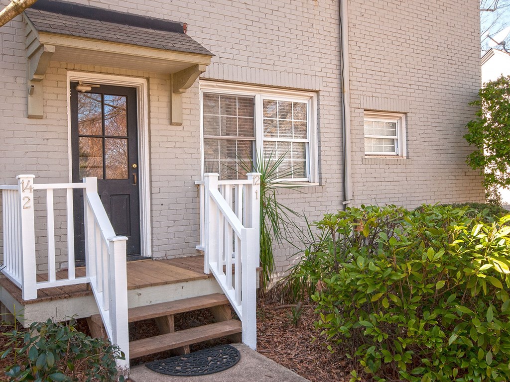 the front of a house with a porch and stairs