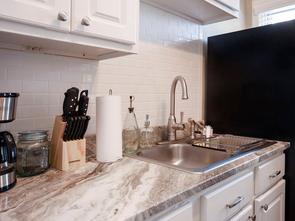a kitchen counter with a sink and a faucet