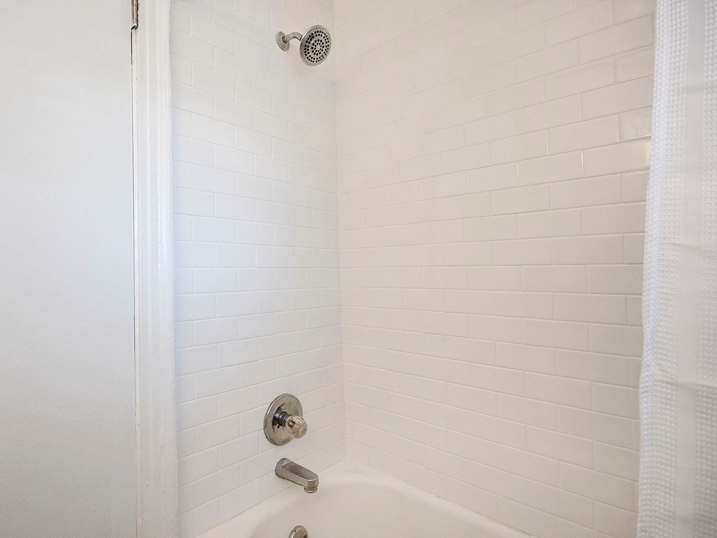 a small bathroom with a shower and a tub