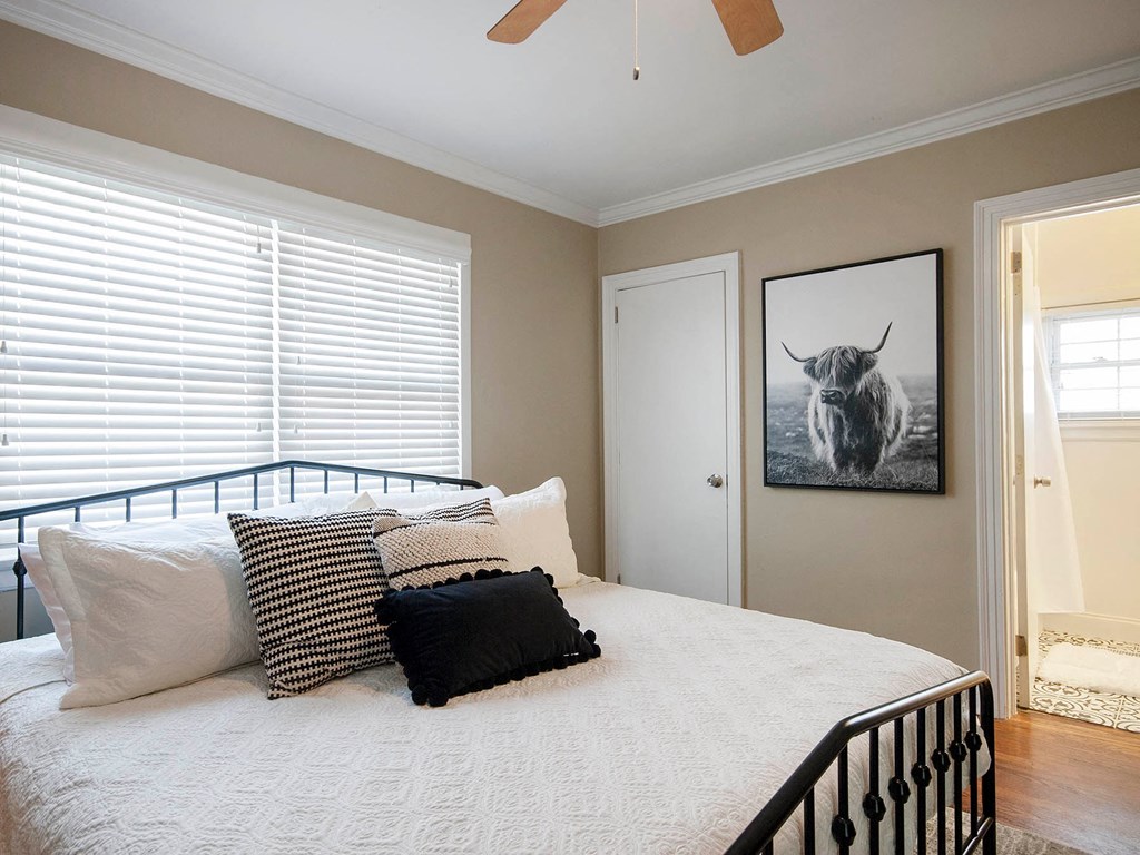 a bedroom with a bed and a picture of a bull