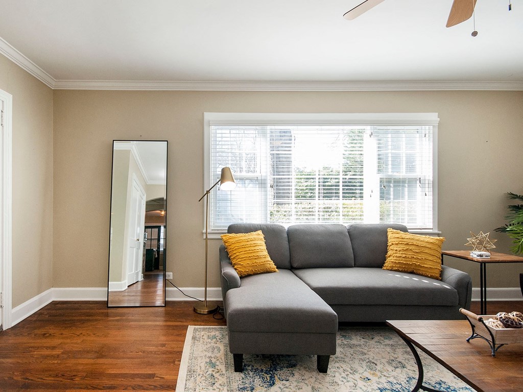 a living room with a couch and a mirror
