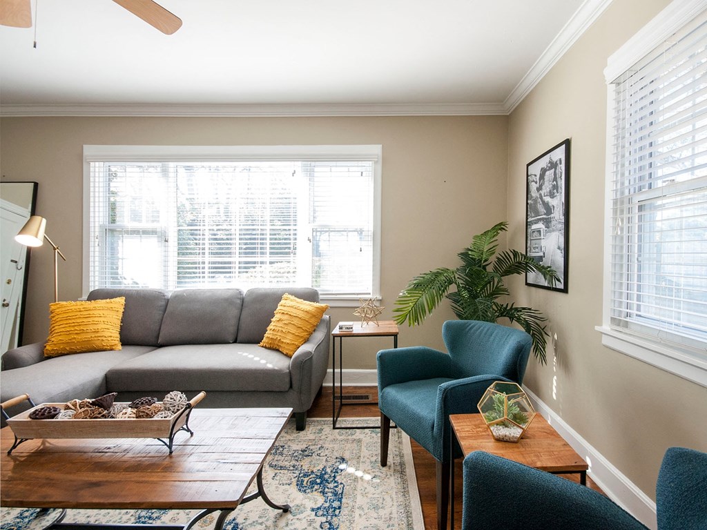 a living room with a couch and chairs and a table