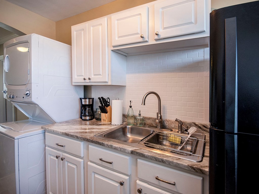 a kitchen with white cabinets and a sink