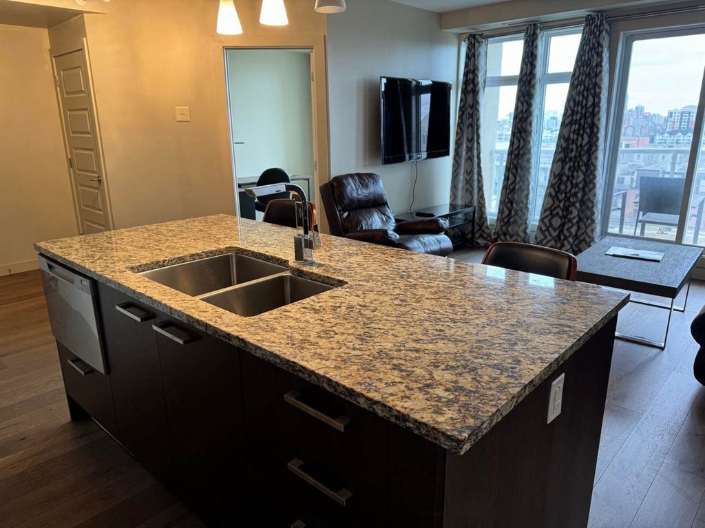 a kitchen with a granite counter top and a sink