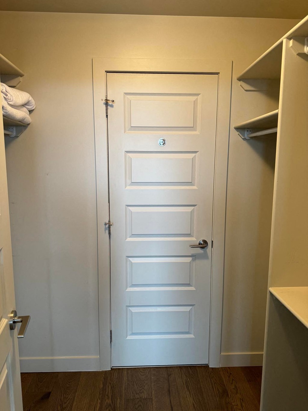 a closet with a white door and shelves