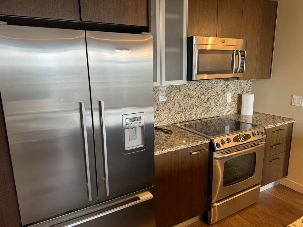 a kitchen with stainless steel appliances and granite counter tops
