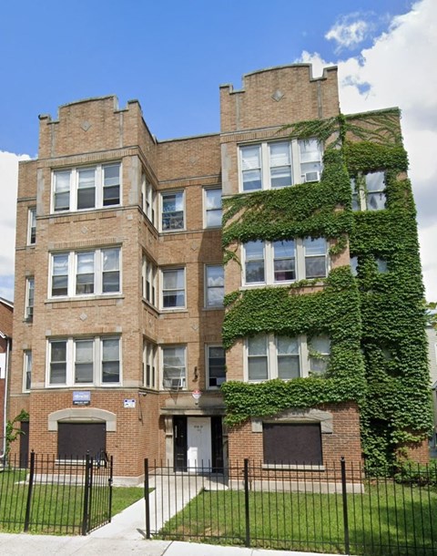 A large building with ivy growing up the side of it.