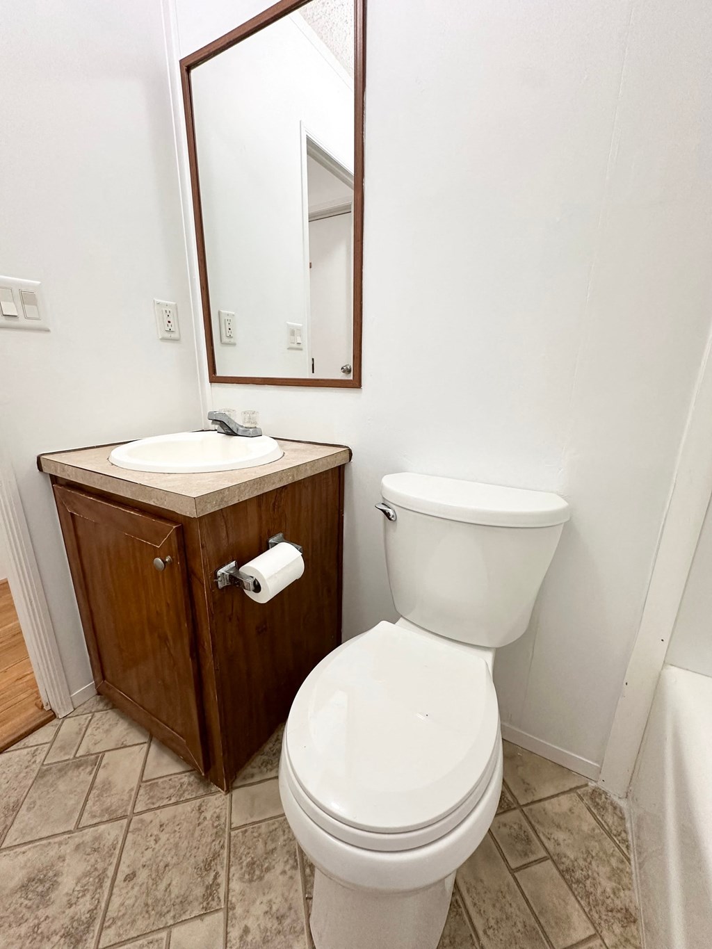 a bathroom with a toilet and a sink and a mirror