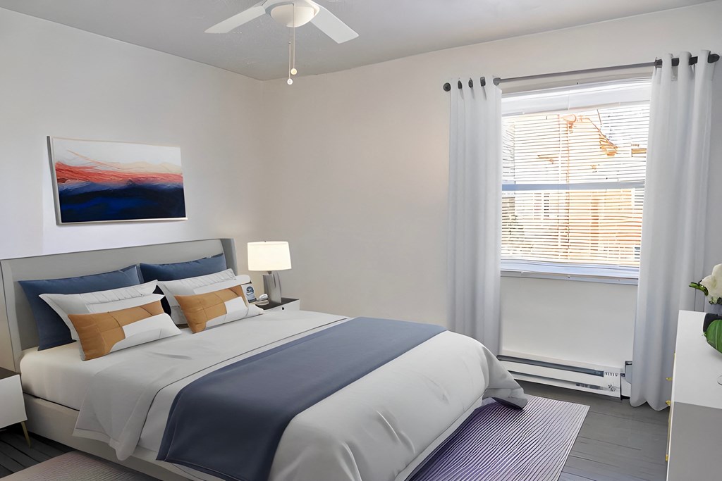 a bedroom with a white bed and blue and white bedding