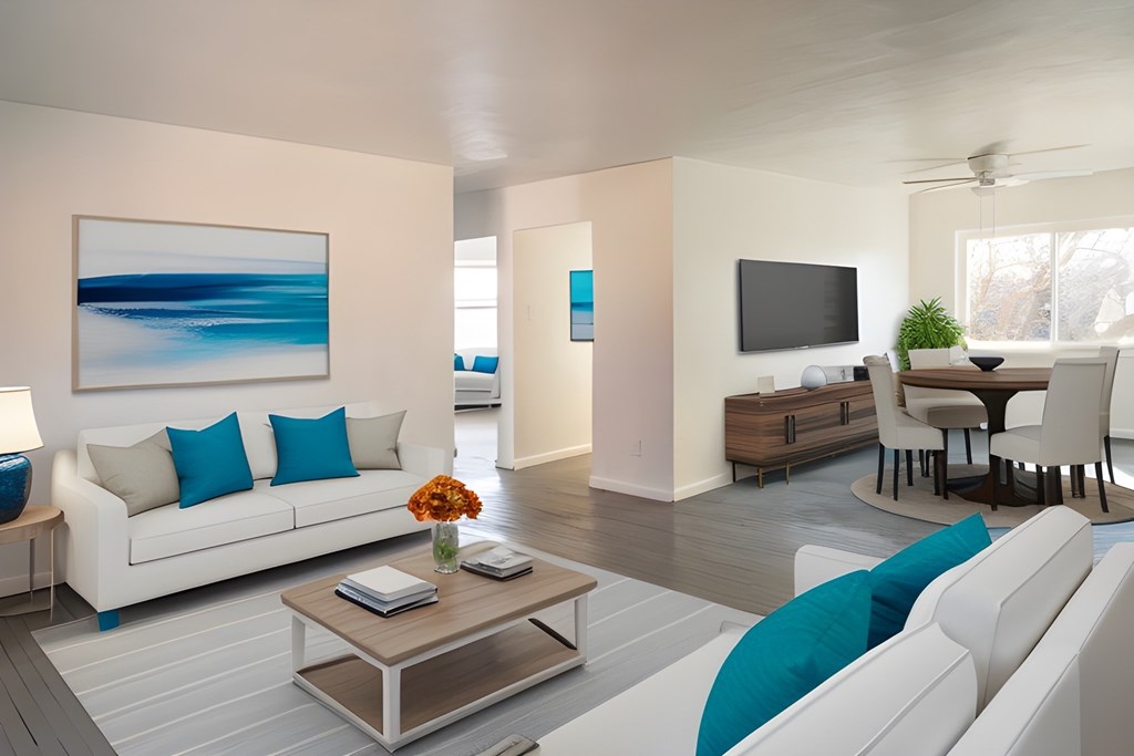 a white living room with blue pillows and a coffee table