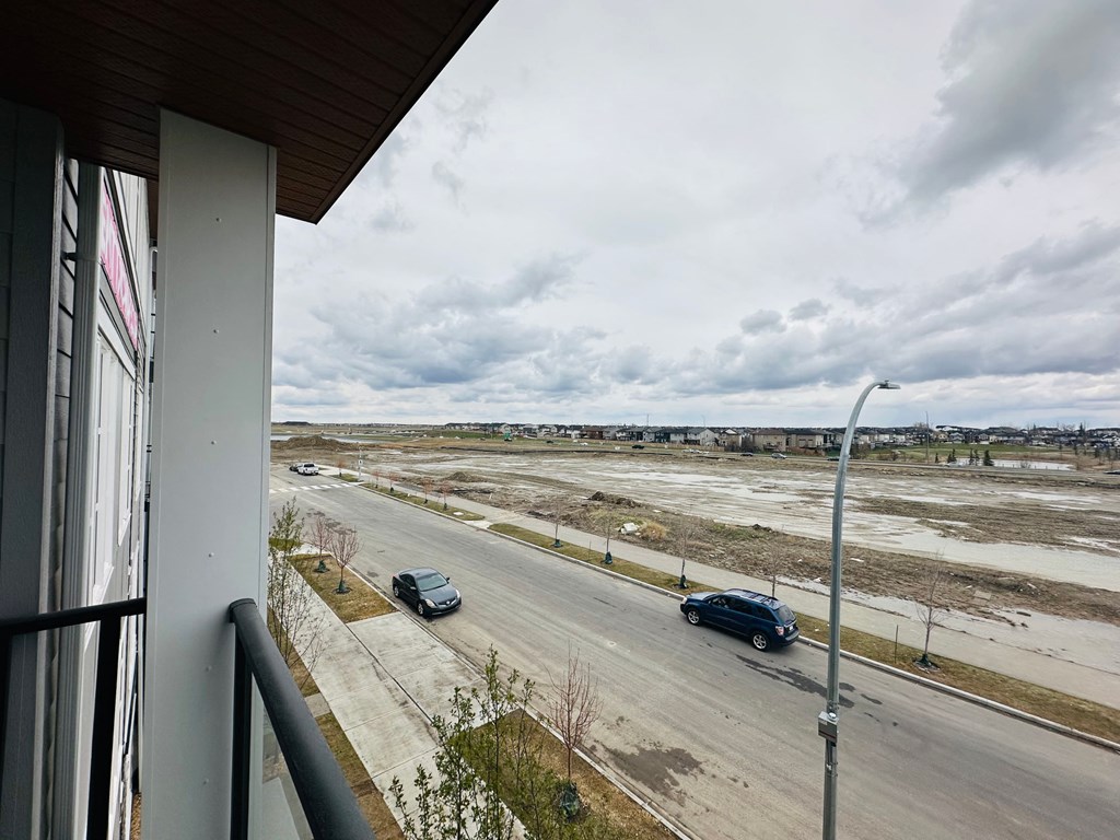 a view from a balcony of cars driving on a road