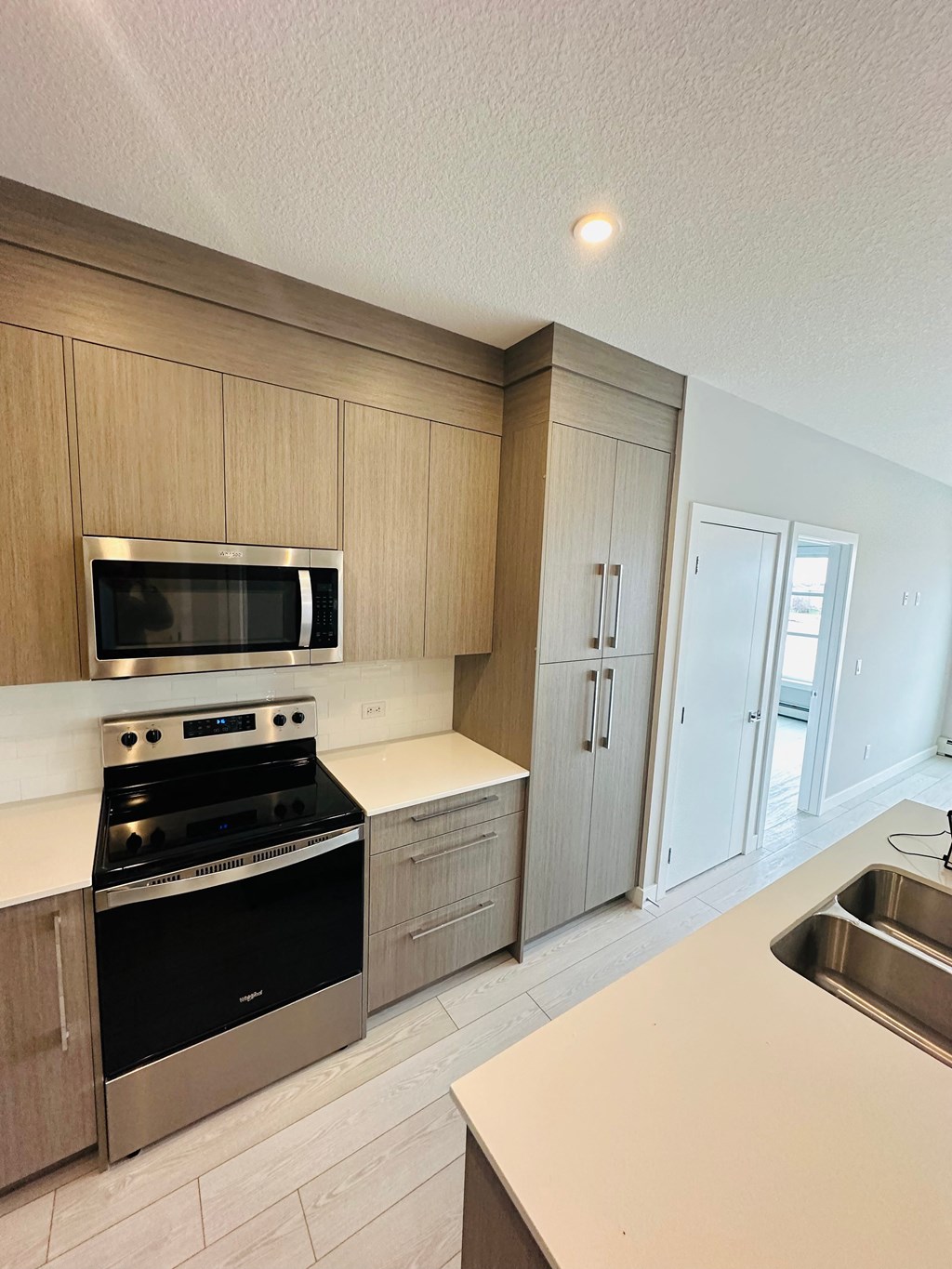 a kitchen with stainless steel appliances and wooden cabinets