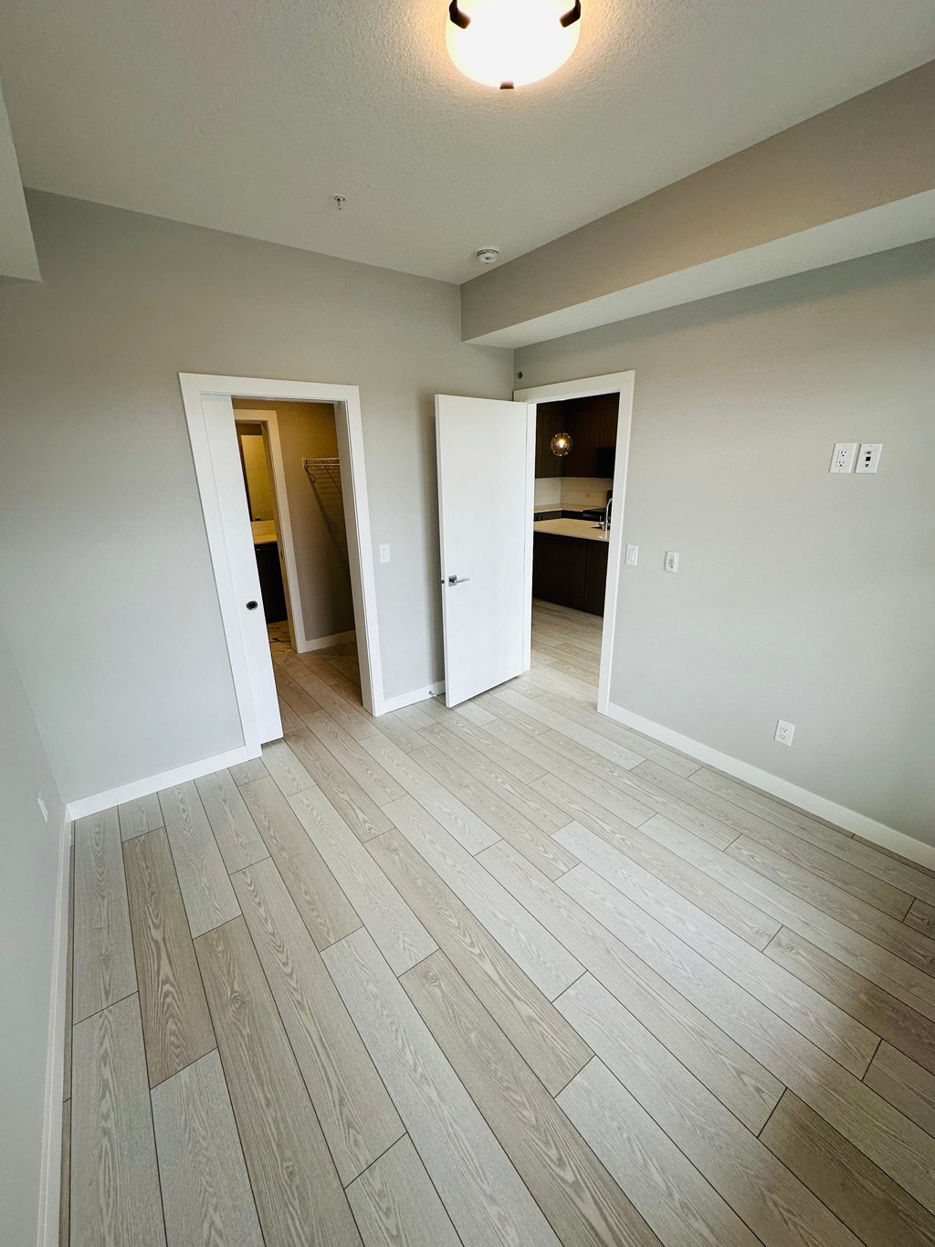 an empty living room with wood flooring  homes