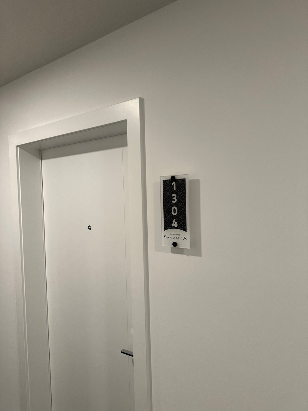 a remote control is hanging on the wall next to a door