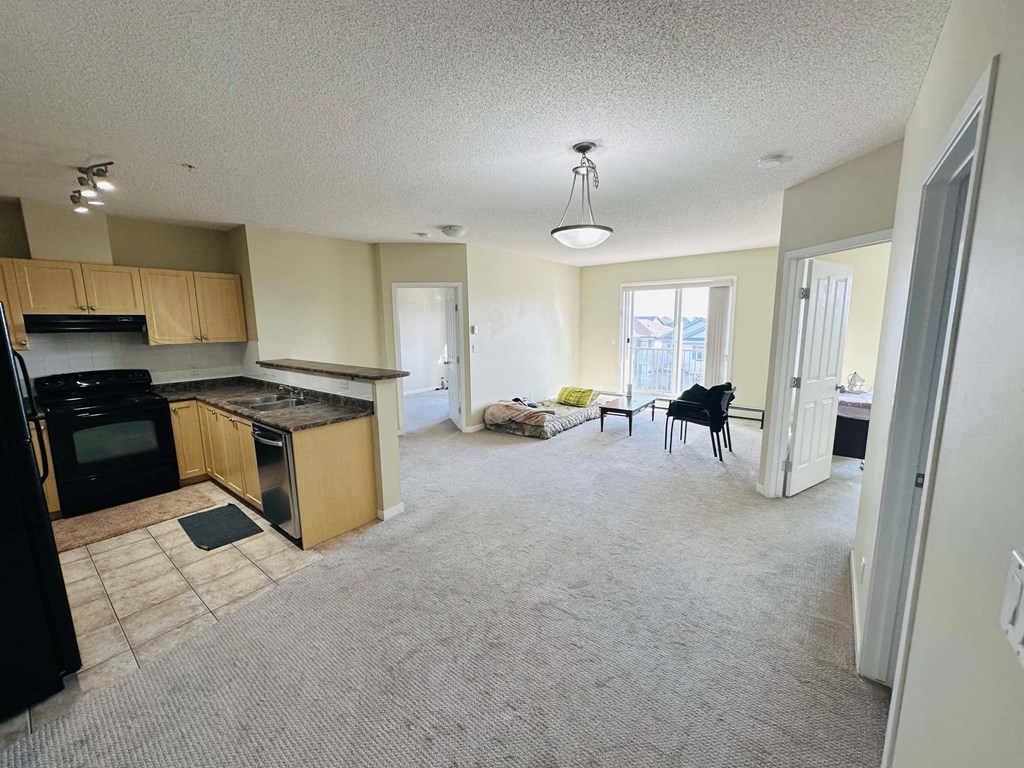 an empty kitchen and living room in a house