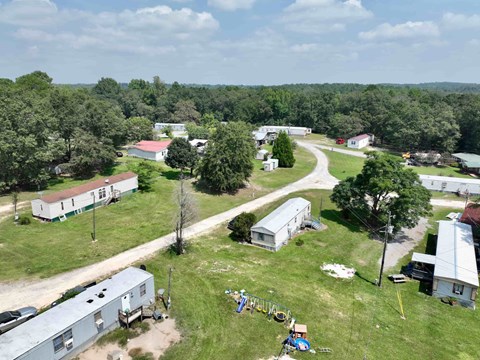 an aerial view of a trailer park with trailers and trees