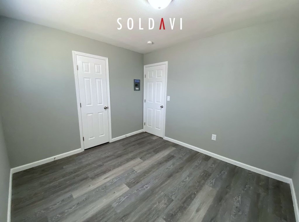 A room with two doors and a sign that says "SOLD AVI".