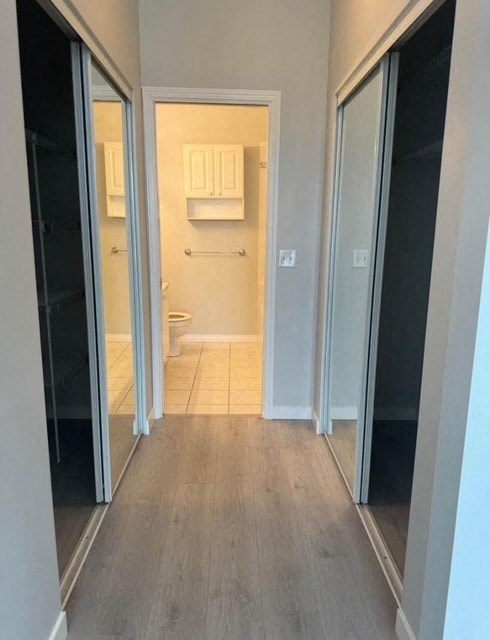 a hallway with sliding glass doors to a bathroom