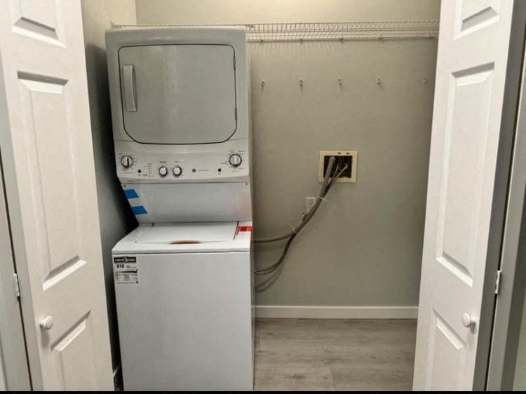 a washing machine sitting on top of a refrigerator in a room