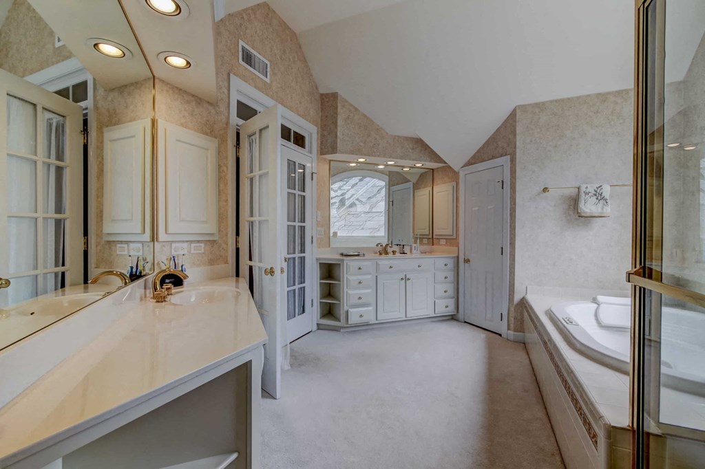 a large bathroom with a sink and a tub