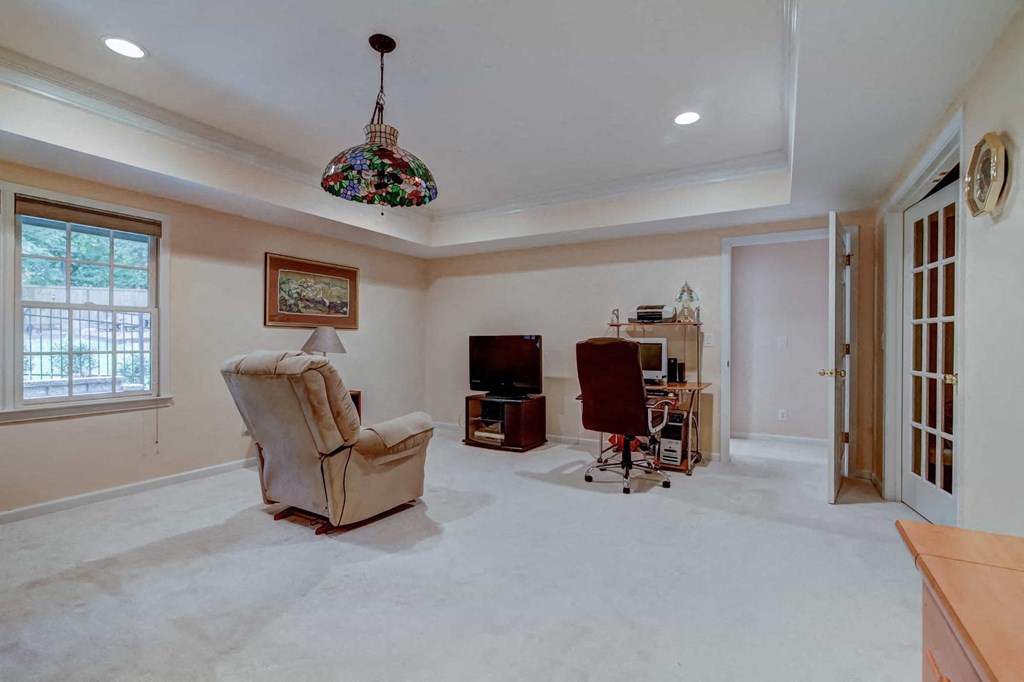 a living room with a chair and a tv
