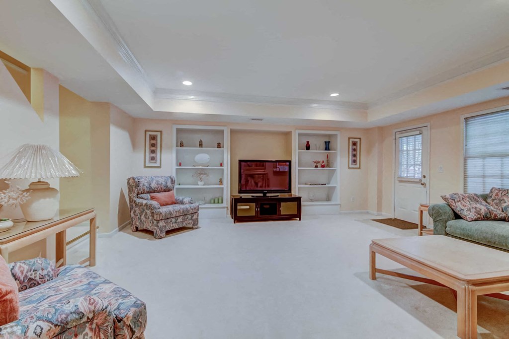 a living room filled with furniture and a television