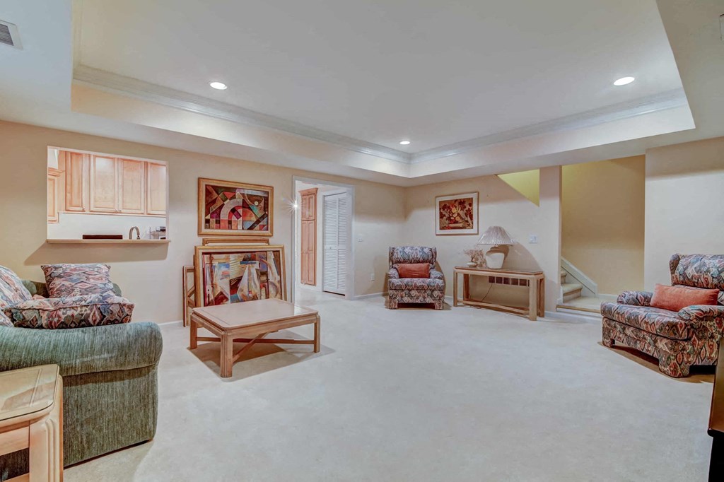 a living room filled with furniture and a staircase