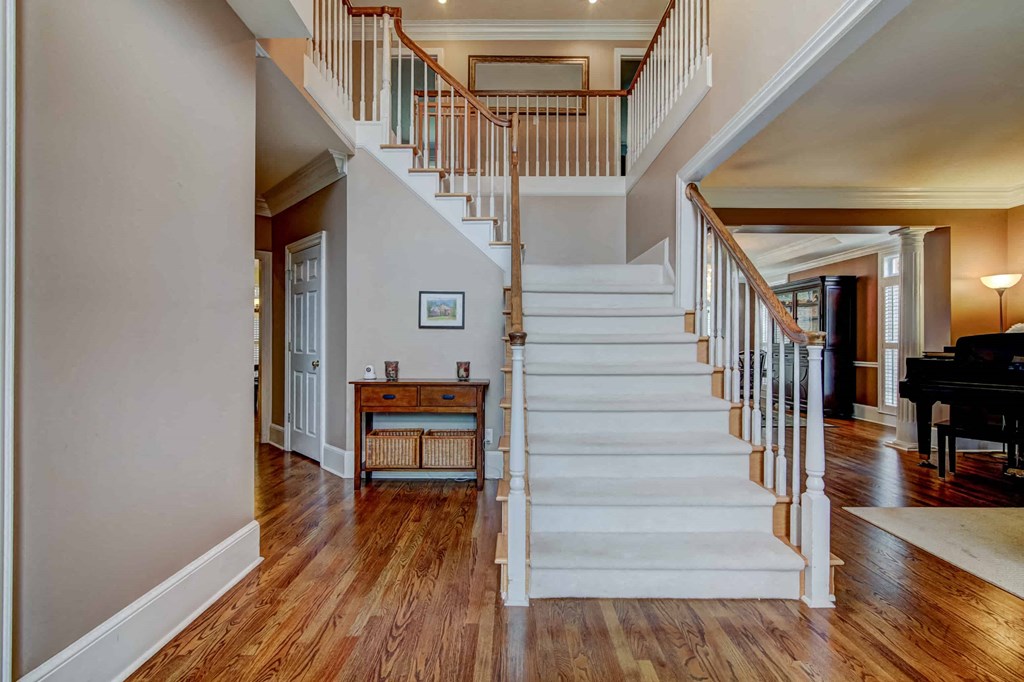 a staircase in a living room with a wooden floor and stairs