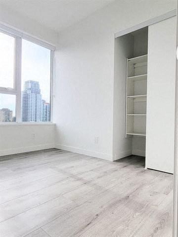 an empty room with a closet and a window