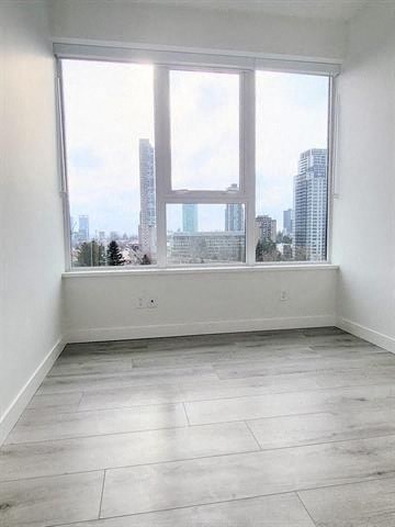 a empty room with a large window with a city view