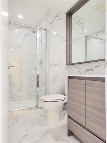 a bathroom with a toilet and a shower