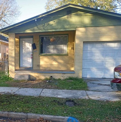 a house with two garage doors on the side of it