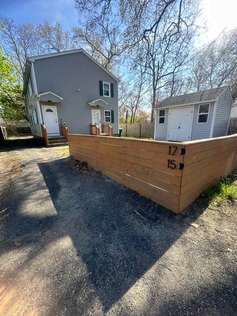 a wooden retaining wall in front of a house