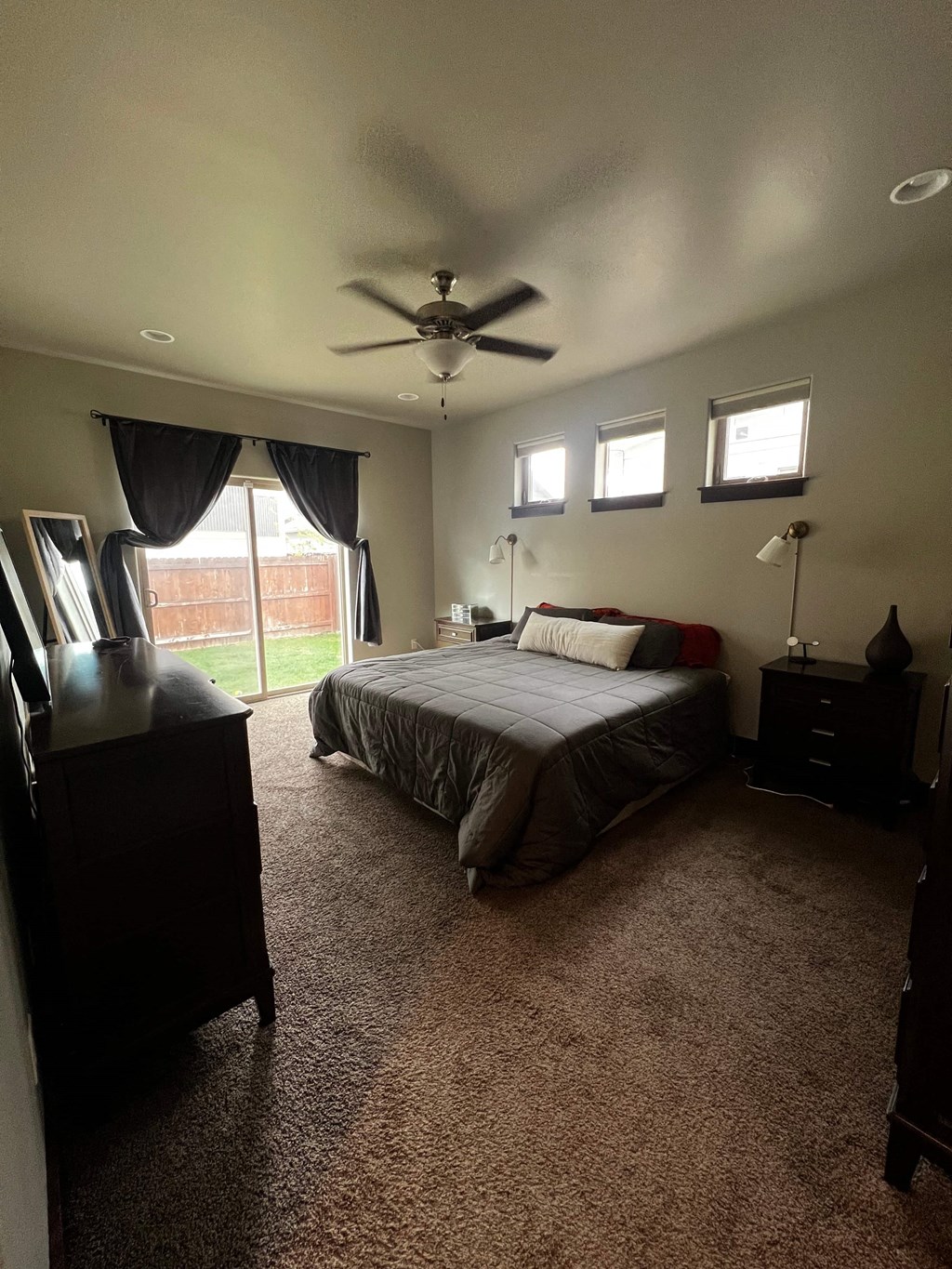 a bedroom with a bed and a ceiling fan