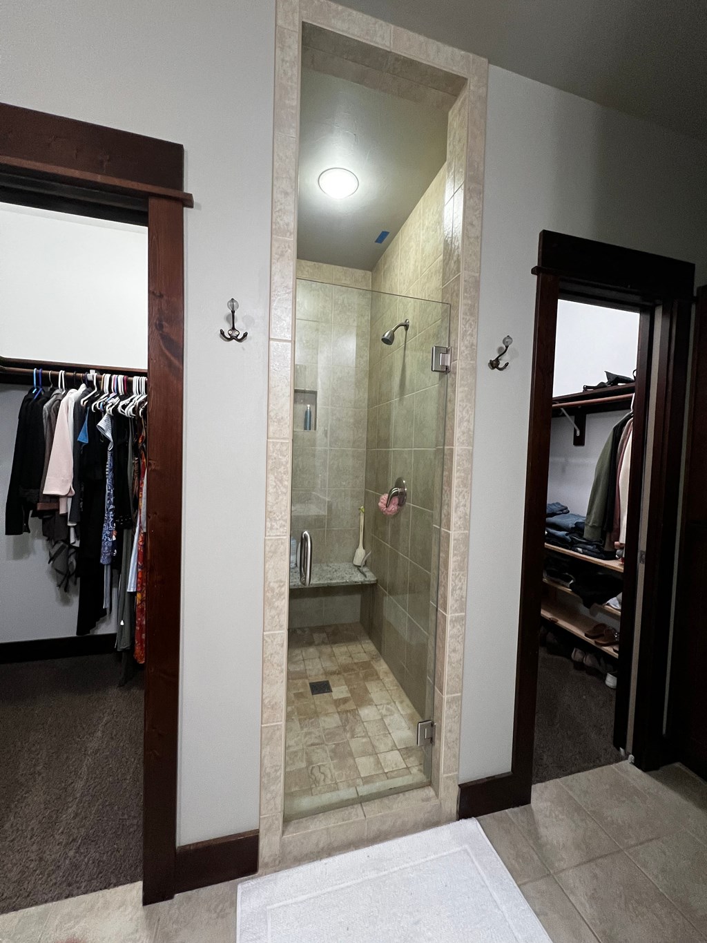 the walk in shower in the master bedroom has a closet and a dresser